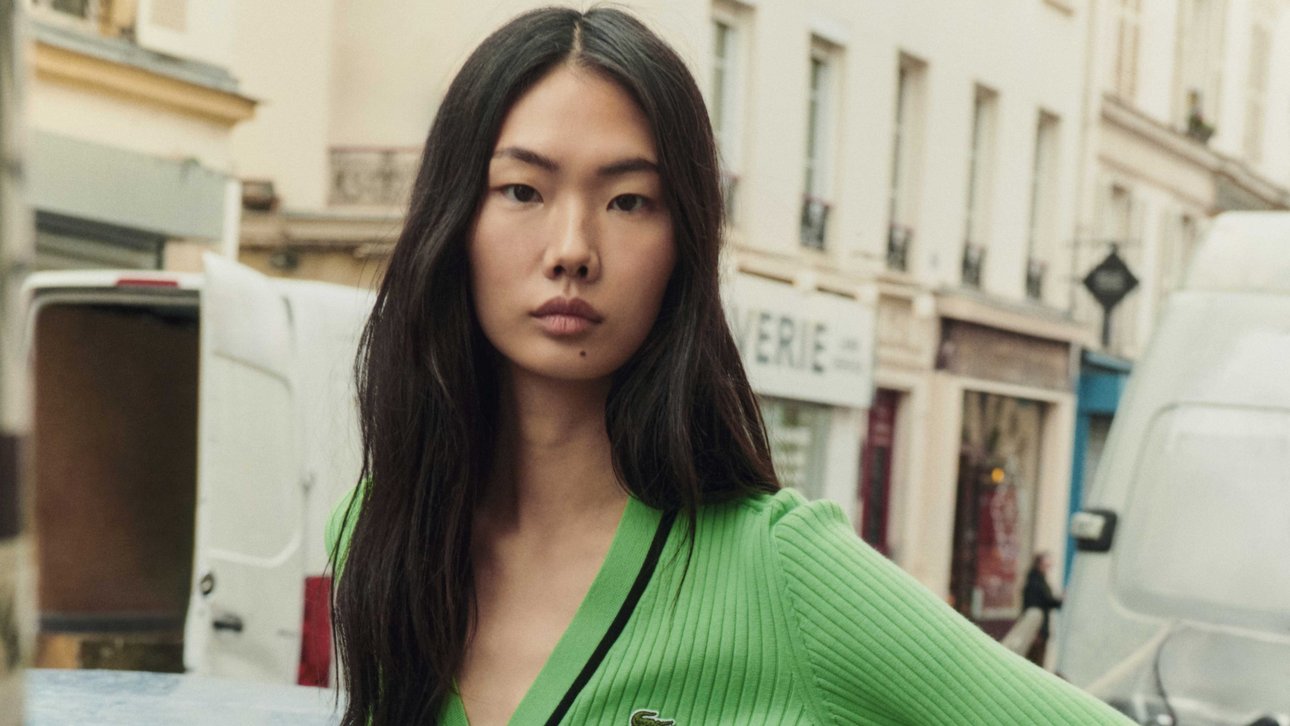 Woman in a green Lacoste sweater